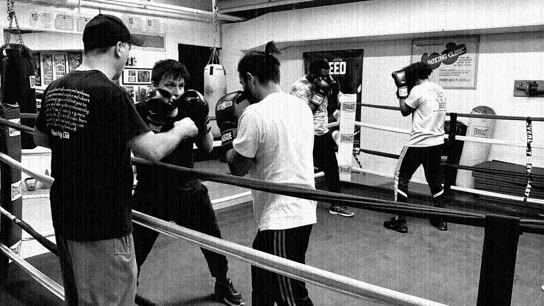 Members working on a ring floor next to the ropes