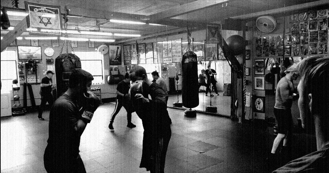 The WBC floor mid-session: heavy bag, speed bag and trainers working with members